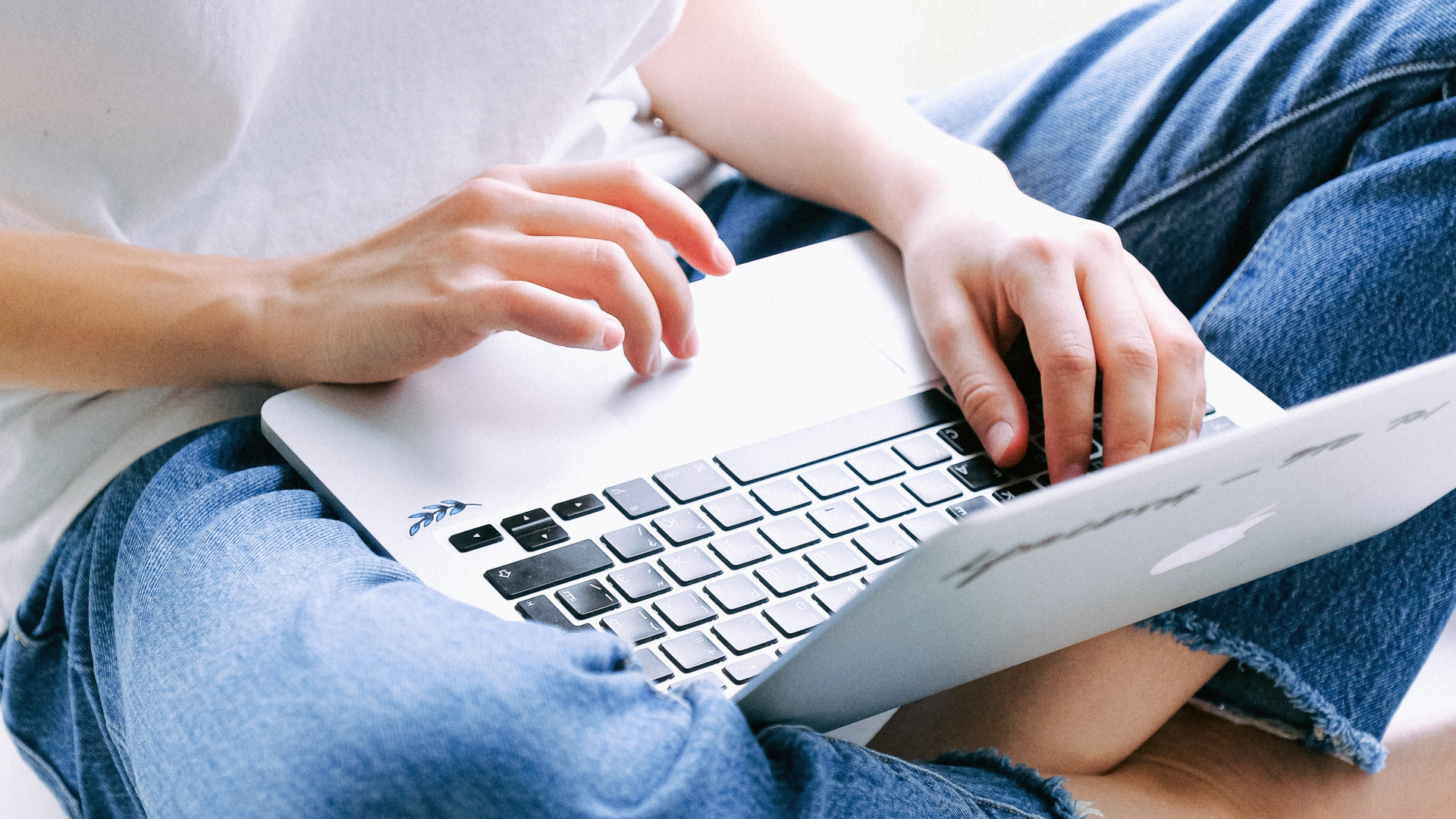 Frau im Schneidersitz mit Laptop